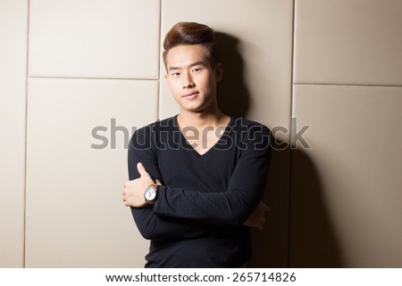 a smart asian man  with the black shirt on the background