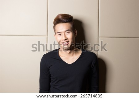 a smart asian man  with the black shirt on the background