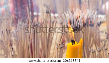 the fire candle and the burning joss stick , burnig candle  and burning  incense