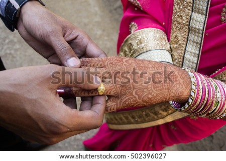 Ceremony. Wear rings. The bride and groom,Close up of Indian couple\'s hands at a wedding, concept of marriage/commitment