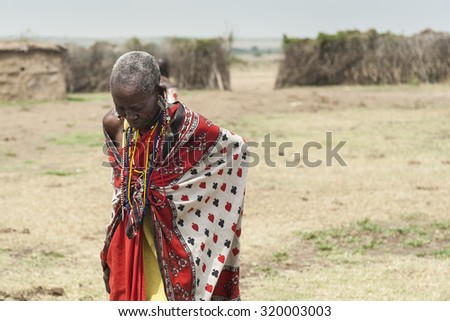 MASAI MARA, KENYA - FEB 2013: Tribe old women looks down in village