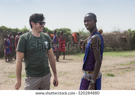 MASAI MARA, KENYA - CIRCA FEBURARY 2013: Tourist talk to local african tribe man