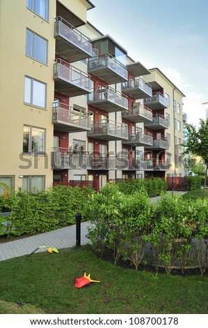 Modern multi-apartments building in summer.