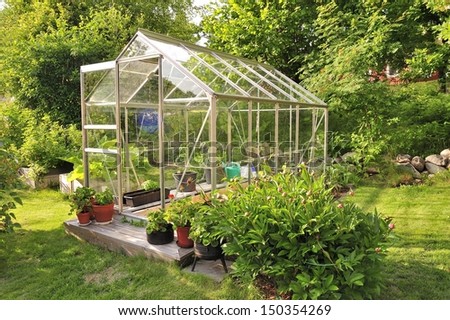 A garden center greenhouse with a colorful display of potted plants and flowers