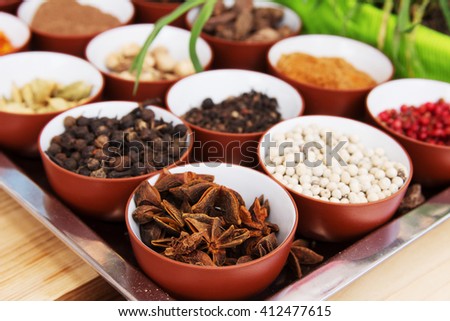 Various spices selection. Indian spices such as star anise, pepper, cumin, cloves, cinnamon, cardamom, in different bowls at the fair or bazaar. Tasty, spices and healthy food.