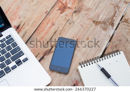 mobile phone laptop  notebook on table
