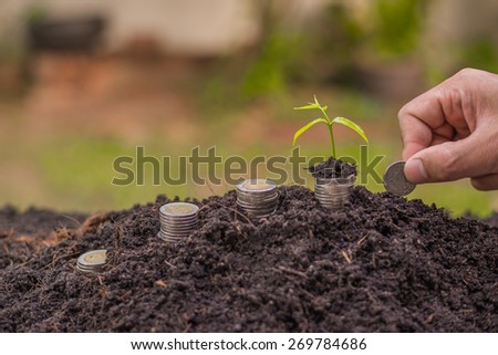 Money, Financial, Business Growth concept, Close-up Of Hand Put Money Coins To Soil