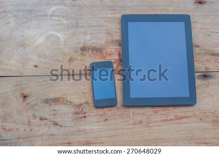 Tablet and Smart phone. Mobile phone and Tablet pc on wooden table