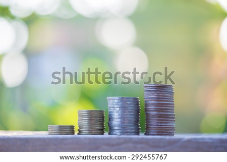 increasing stack of money coins, saving money.