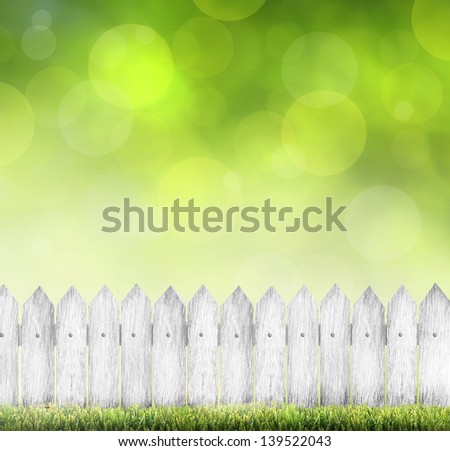 green grass and wood fence over bokeh