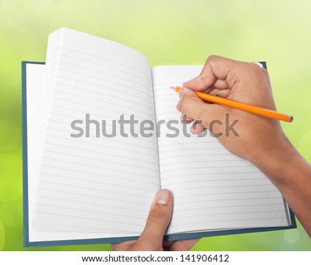 hand holding blank note pad and  pencil
