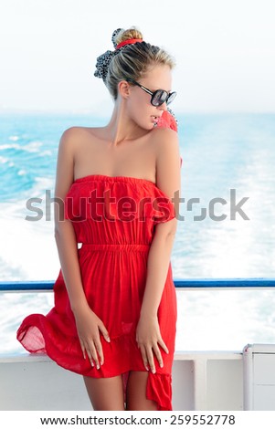 Cruise ship woman on boat in happy free pose smiling enjoying freedom. Young woman traveling on vacation travel sailing on open sea ocean. Young white race Europe woman.