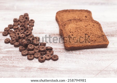 rye bread and chocolate flakes on a brown background
