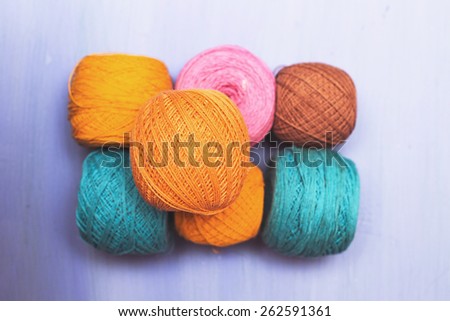 balls of wool of different colors on a blue background