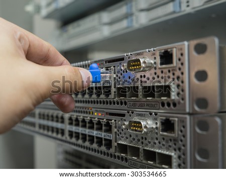 Network engineer plug lan cable to ethernet switch
