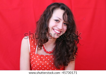 Beautiful young smiling  business woman wearing red dress on red  background