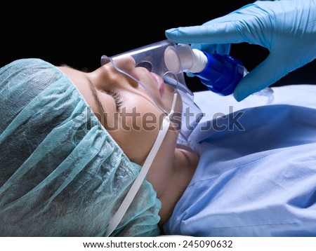 Closeup of a girl in an operating room with anesthesia mask