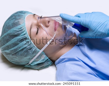 Closeup of a girl in an operating room with anesthesia mask