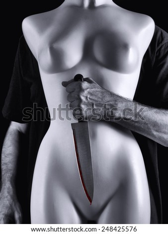 A man with a knife, attacking to a woman\'s mannequin