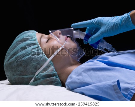 Girl in an operating room with anesthesia mask