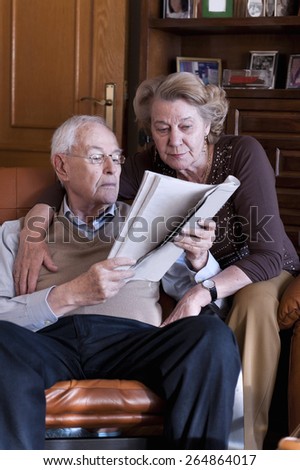 Elders, embraced marriage, reading the newspaper