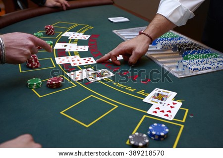 A close up of a blackjack dealer\'s hands in a casino, very shallow depth of field