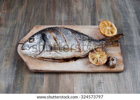 Prepared fish on on the old wooden table