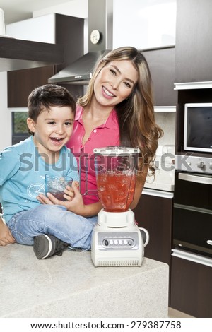 Mother and son in the kitchen of his home with blender