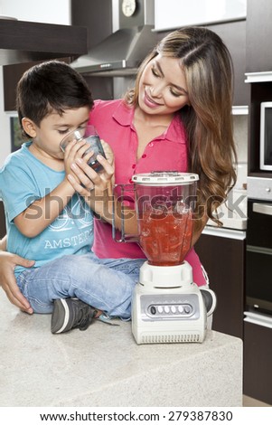 Mother and son in the kitchen of his home with blender
