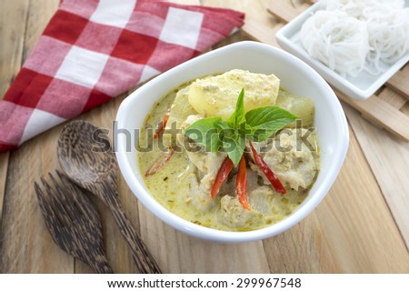 THAI SPICY FOOD : Green curry fish balls and noodles with old wooden background, Thai cuisine.
