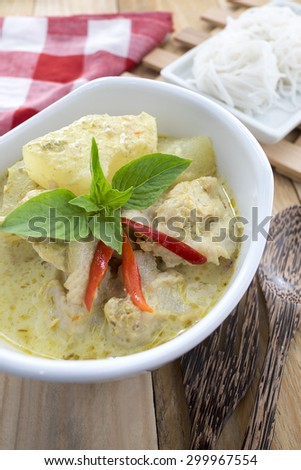 Thai Cuisine : Thai Spicy Recipe, Green Curry Fish Balls (Ka nom jeen Gaeng Khiao Waan Look Chin Pla Krai/Ka-nom-jeen-Gaeng-Khiao-Waan-Look-Chin-Pla-Krai) with rice vermicelli on Wooden background.