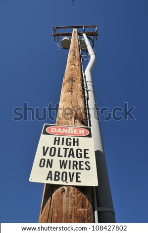 Telephone pole with a high voltage sign