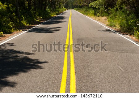Traffic lines lead into the distance on a country road