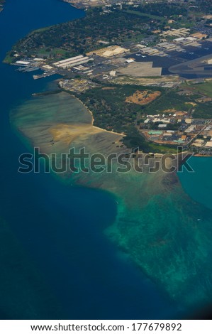View of a tropical beach and ocean from an airplane