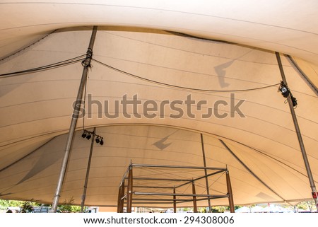 Top inside of a large tent with lights and cables