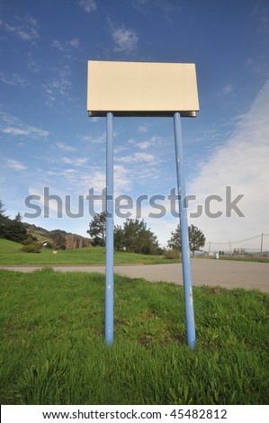 Two long poles hold up a blank sign