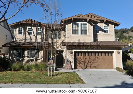 Single family house with two stories and a short driveway