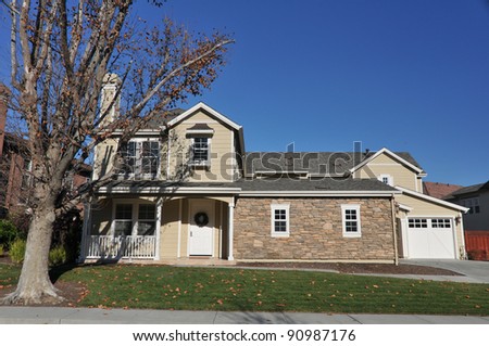 Single family house with two stories and a short driveway