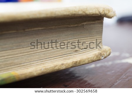 Selective focus of the side of the old book on the table
