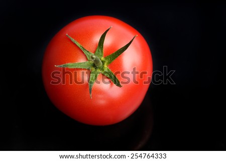 fresh tomato on black background