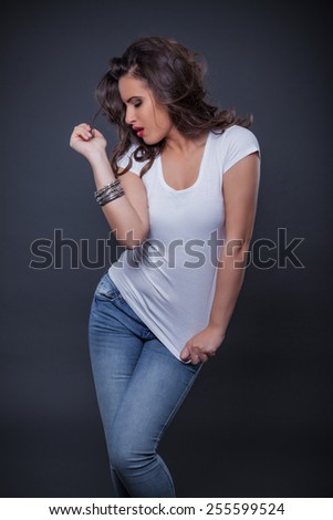 Beautiful girl posing on gray background.Studio shoot.