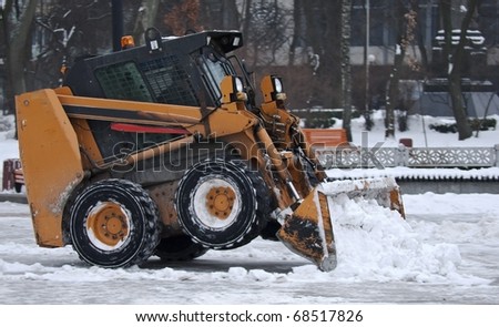 Excavator clears snow on the streets of Kiev Ukraine