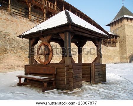 Wooden well in old castle in winter
