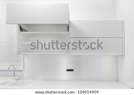 Opened white kitchen cabinet