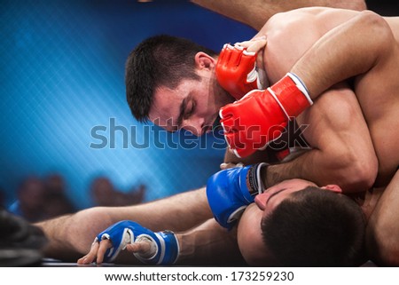 ZAGREB, CROATIA - NOVEMBER 2, 2013: Final fights at Croatian MMA legaue. Anto RADMAN (red gloves) VS Tonci PERUSKO (blue gloves).