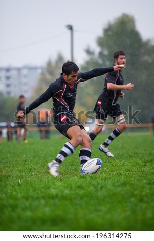ZAGREB, CROATIA - OCTOBER 12, 2013: Friendly rugby match between RC Mladost (red-yellow jersey) and Austrian National Team (black jersey).  Unidentified Austria player shooting ball