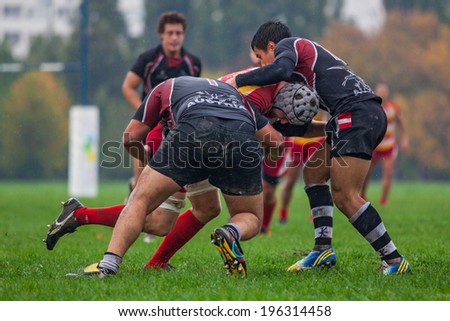 ZAGREB, CROATIA - OCTOBER 12, 2013: Friendly rugby match between RC Mladost (red-yellow jersey) and Austrian National Team (black jersey).  Unidentified players in action