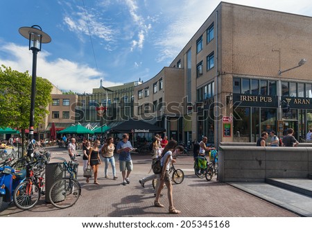 AMSTERDAM, NETHERLANDS - AUGUST 1, 2012: Tourists on the Max Euweplein, popular hangout place for young people. On the square there is Hard Rock Caffe, Irish Pub and Holland Casino.