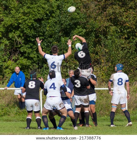 ZAGREB, CROATIA - SEPTEMBER 13, 2014: Croatian Rugby league - RC Zagreb Old Lions (white jersey) VS RC Sinj (dark blue jersey). Players jump for the ball