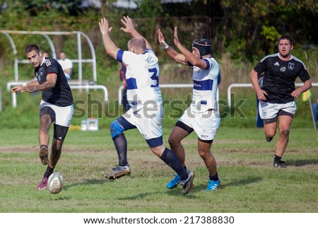 ZAGREB, CROATIA - SEPTEMBER 13, 2014: Croatian Rugby league - RC Zagreb Old Lions (white jersey) VS RC Sinj (dark blue jersey). Unidentified player shooting the ball